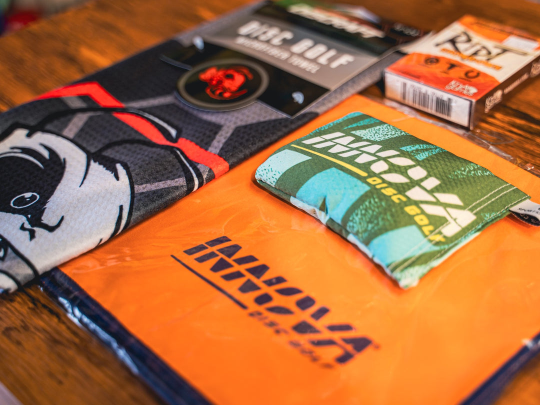 an assortment of towels and bags for disc golf